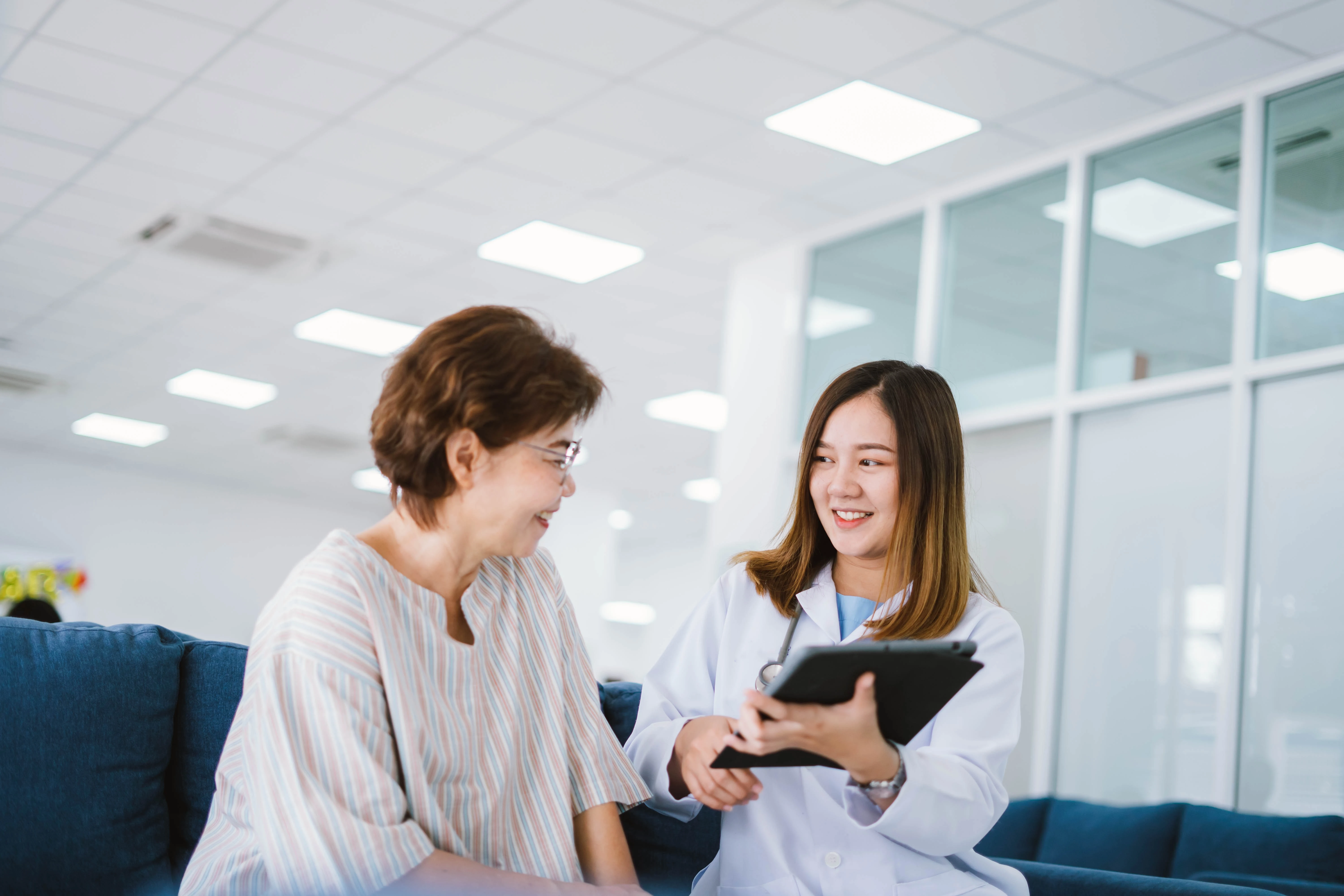 Doctor reviewing medical records with patient Doctor reviewing medical records with patient